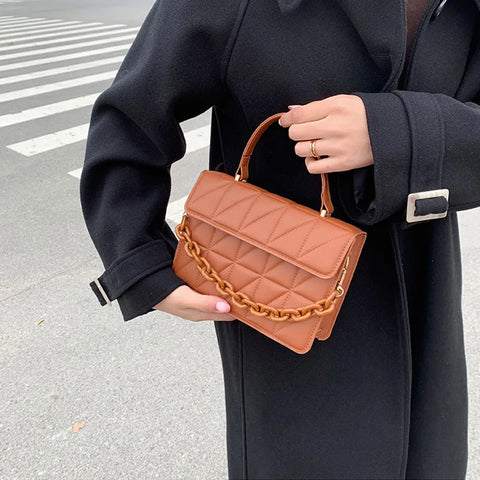 Chic Checkmate: Chain-Embellished Crossbody