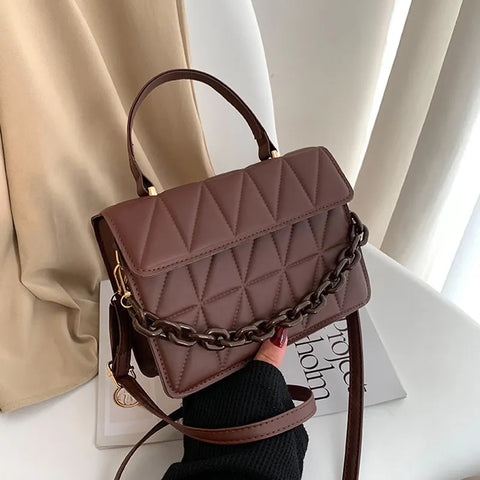 Chic Checkmate: Chain-Embellished Crossbody